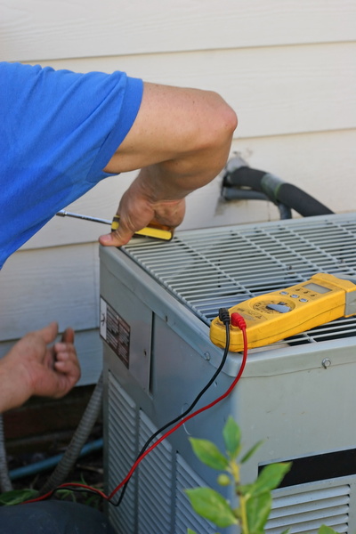 technician working on outdoor ac unit