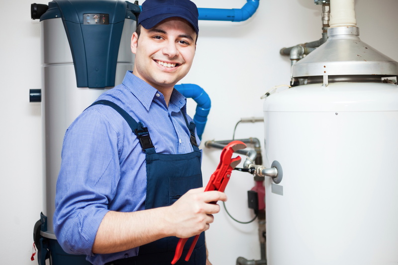 technician performing maintenance on a water heater